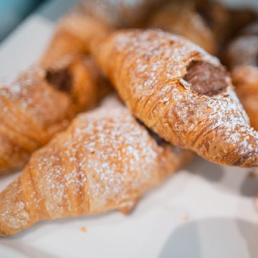 Chocolate-filled croissants, dusted with powdered sugar.